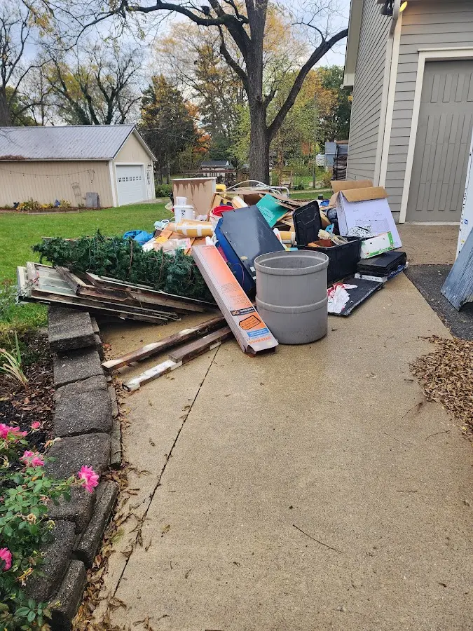Dumpster being loaded with debris for Estate Cleanout Dumpster Rental in Rockledge